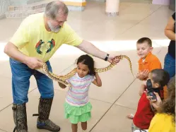  ?? COURTESY PHOTO ?? ABOVE: Tom Wyant shows snakes to the kids of Northern Youth Sports Program.