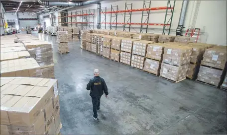  ?? Los Angeles County ?? WHEN FULL, L.A. County’s warehouse is packed with brown shipping boxes stacked together on wooden pallets wrapped in plastic.