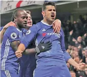  ?? AFP ?? Chelsea’s Diego Costa (right) celebrates his goal with teammates in their Premier League match against Hull City at Stamford Bridge in London on Sunday. The hosts won 2-0. —