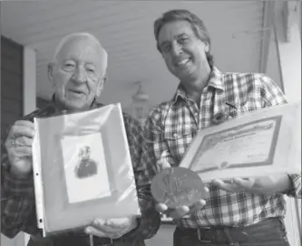  ?? PETER LEE, RECORD STAFF ?? Don Haber, left, holds a photograph of his uncle, Frank McKinnon, who was killed at Passchenda­ele on Nov. 18, 1917. Don’s son, Bill, holds a Next of Kin Memorial Plaque and death certificat­e for McKinnon.