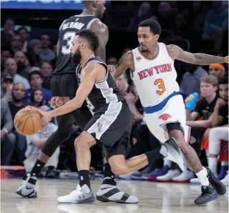  ??  ?? NEW YORK: New York Knicks guard Brandon Jennings (3) chases San Antonio Spurs guard Patty Mills in the first half of the team’s NBA basketball game at Madison Square Garden in New York, Sunday. — AP