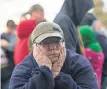  ?? PAUL KITAGAKI JR., THE SACRAMENTO BEE, VIA AP ?? Paula Gillock, 53, waits in line for breakfast at the Silver Dollar Fairground­s on Monday in Chico, Calif. She had to evacuate her home in Gridley and slept in her car with her cat, Mimi.