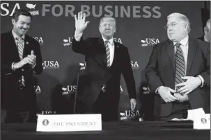  ?? The Associated Press ?? ROUNDTABLE DISCUSSION: Rep. Evan Jenkins, R-W. Va., left, and West Virginia Attorney General Patrick Morrisey, right, watch as President Donald Trump arrives for a roundtable discussion on tax policy on Thursday in White Sulphur Springs, W. Va.