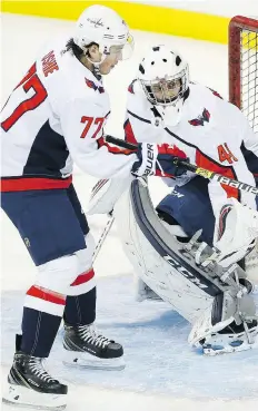  ?? WOODS / THE CANADIAN PRESS JOHN ?? Goalie Gavin Mchale warms up alongside T.J. Oshie as the Caps prepared to face the Jets on Wednesday. Mchale was an emergency call-up.