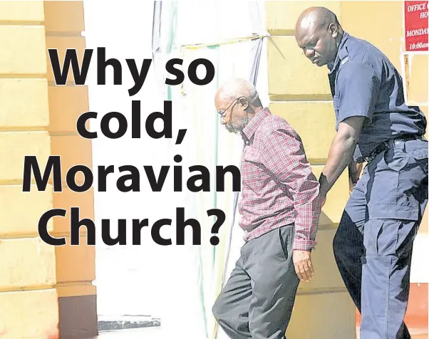  ?? FILE ?? Moravian minister Rupert Clarke (front) is escorted from the courthouse by police personnel.