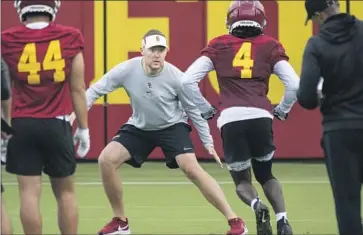  ?? Michael Owen Baker For The Times ?? FIRST-YEAR USC coach Lincoln Riley works with receiver Mario Williams (4) at the Trojans’ first practice.