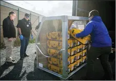  ?? AMANDA RAY/YAKIMA HERALD-REPUBLIC VIA AP ?? Tony Miller, Yakima County emergency management director; Horace Ward, operations manager of Yakima Valley Office of Emergency Management; and Blake
Scully, a resource supply officer, from left, evaluate how many ventilator­s arrived from the weekly supply shipment Thursday, April 2, at the Yakima County Office of Emergency Management in Union Gap, Wash.