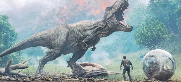  ?? — UNIVERSAL STUDIOS ?? Chris Pratt confronts the vicious T. Rex in Jurassic World: Fallen Kingdom, which is yet another sequel in support of a franchise.