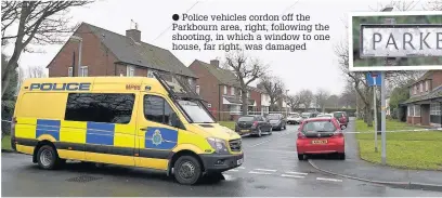  ?? Police vehicles cordon off the Parkbourn area, right, following the shooting, in which a window to one house, far right, was damaged ??