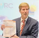  ?? JIM THOMPSON/JOURNAL ?? Mayor Tim Keller holds a list of languages and translator contacts. Police officers will have the list when they respond to domestic violence calls.