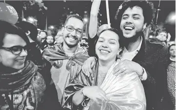  ??  ?? People celebrate after Colombia’s government and Revolution­ary Armed Forces of Colombia (FARC) rebels reached a final peace deal on Wednesday to end a five-decade war, in Bogota, Colombia. — Reuters photo