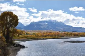  ?? (AP Photo/Matthew Brown, File) ?? In this Oct. 8, 2018 file photo, emigrant Peak is seen rising above the Paradise Valley and the Yellowston­e River near Emigrant, Mont. Lawmakers have reached bipartisan agreement on an election-year deal to double spending on a popular conservati­on program and devote nearly $2 billion a year to improve and maintain national parks.