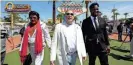  ?? GETTY IMAGES ?? An Elvis Presley impersonat­or walks by Raiders owner Mark Davis (center) and former Raiders player Marcel Reese during an event celebratin­g the NFL draft in Las Vegas.