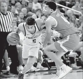  ?? Photograph­s by Luis Sinco Los Angeles Times ?? USC’S DERRYCK THORNTON drives to the basket against UCLA’s Jaylen Hands during the Trojans’ victory. A 17-0 run in the second half keyed USC.