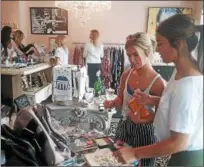  ?? JEAN BONCHAK FOR THE NEWS-HERALD ?? Danielle Holley, left, and Maddy Frate, both of Concord Township, peruse the products offered at Britash, a new boutique in Mentor.