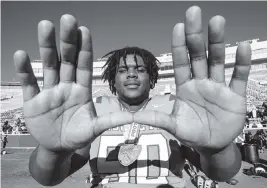  ?? DANIEL A. VARELA dvarela@miamiheral­d.com ?? Miami Central guard and UM signee Laurence Seymore celebrates by throwing up ‘The U’ after defeating Lake Minneola 46-0 at Doak Campbell Stadium in Tallahasse­e.