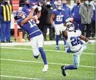  ?? Corey Sipkin / Associated Press ?? The New York Giants’ Dante Pettis, left, makes a catch in front of the Dallas Cowboys’ Xavier Woods during the first half on Jan. 3.