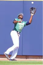  ?? ROY DABNER / SPECIAL TO THE JOURNAL SENTINEL ?? Lorenzo Cain makes a catch at the warning track against the Rockies on Saturday.