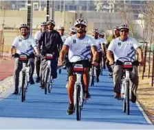  ?? Ahmed Kutty/Gulf News ?? Shaikh Tayyeb (centre) and others cycle from Irena HQ to Masdar Park celebratin­g the opening of the two new stations.