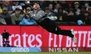  ?? Photograph: Dan Himbrechts/AAP ?? New Zealand’s Glenn Phillips dives to catch Australia’s Marcus Stoinis in the Black Caps’ opening Super 12s win.