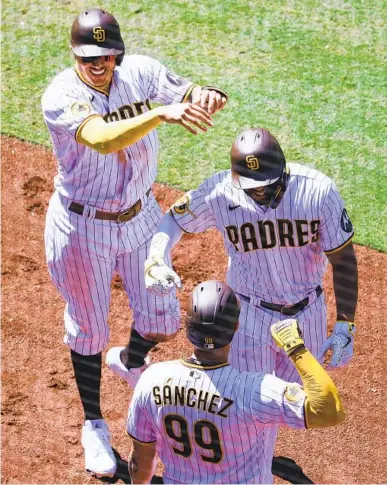  ?? MEG MCLAUGHLIN U-T ?? Manny Machado (left) and Gary Sánchez celebrate a two-run home run by Xander Bogaerts (right) in sixth inning.