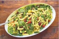  ?? ASSOCIATED PRESS ?? You can make this pasta salad ahead of time, but add the greens right before serving so they don’t wilt.