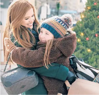  ?? DISNEY+ ?? Isla Fisher hugs Willa Skye in the TV movie“Godmothere­d,”which was directed by Sharon Maguire, best known for directing“Bridget Jones’s Diary.”