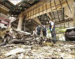  ?? TUWAEDANIY­A MERINGING/AFP ?? A forensics unit inspects the site of a deadly bomb blast outside a hotel in Pattani province yesterday.