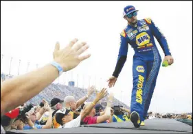  ?? Ap pHoto ?? Chase Elliott greets fans before a NASCAR Cup Monster Energy Series auto race at Chicagolan­d Speedway in Joliet, Ill.