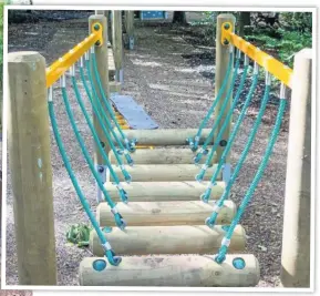  ??  ?? A brand new log bridge and swings (left) at the newly opened advenutre playground in Worsley Woods.