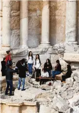  ??  ?? Syrian musicians play at the site of the damaged Roman amphitheat­er.