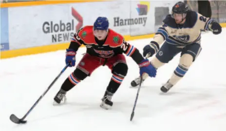  ?? CITIZEN PHOTO BY JAMES DOYLE ?? Prince George Spruce Kings forward Craig MacDonald protects the puck while getting past Langley Rivermen defender Brian Scoville on Friday night at Rolling Mix Concrete Arena.