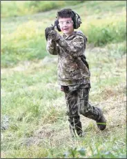  ?? NWA Democrat-Gazette/FLIP PUTTHOFF ?? Ethan Simpson, 5, runs to show his dad a dove taken by one of the hunters. Ethan used a BB gun.