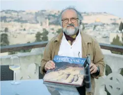  ?? (Juliane Helmhold) ?? PHOTOGRAPH­ER ENRICO Formica presents his new book ‘Terra Sancta,’ published in honor of the 130th anniversar­y of the Notre Dame Pilgrim Center in Jerusalem.