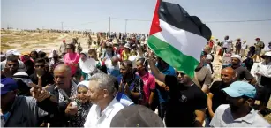  ?? (Mussa Qawasma/Reuters) ?? PEOPLE RALLY in 2015 against the planned demolition of Sussiya, near Hebron.