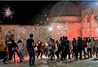  ?? AFP ?? Stun grenades burst in the air amid clashes between Palestinia­n protesters and Israeli security forces at the Al Aqsa mosque compound in Jerusalem. —