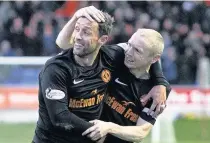  ??  ?? HEDGE CUTTER McDonald celebrates with Willo Flood after putting United ahead at Glebe Park