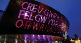  ?? GEOFF CADDICK ?? Wales Millennium Centre in Cardiff – Wales is illuminate­d purple by the Office for National Statistics to mark Census Day 2021