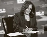  ?? Drew Angerer / Getty Images ?? U.S. Sen. Kamala Harris signs required documents to be nominated for vice president on Aug. 14.
