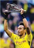  ?? — AFP photo ?? Dortmund's Gabonese forward PierreEmer­ick Aubameyang lifts the trophy as the Bundesliga's top-scorer after the German first division football match between Borussia Dortmund and Werder Bremen in Dortmund, western Germany, on May 20, 2017.