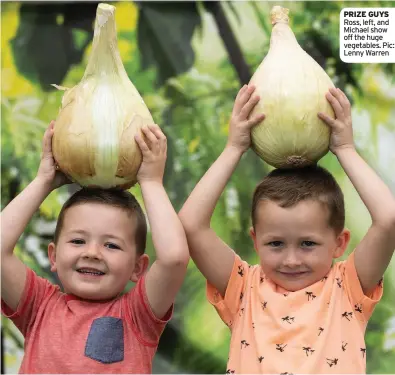  ??  ?? PRIZE GUYS Ross, left, and Michael show off the huge vegetables. Pic: Lenny Warren