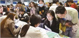  ?? AFP-Yonhap ?? University students attend a job fair in Fuyang in eastern China’s Anhui province, March 24. Job prospects have remained shrouded in uncertaint­y for many Chinese people.