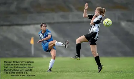  ?? WARWICK SMITH/STUFF ?? Massey University captain Aniek Hilkens clears the ball past Palmerston North Marist’s Katrina Trewhitt. The game ended 3-3.