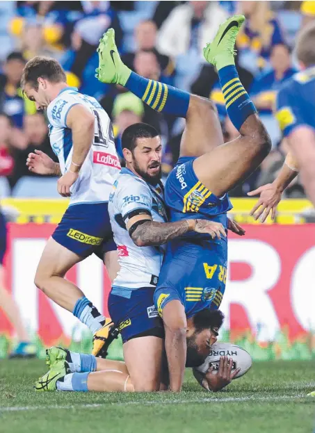  ?? Picture: AAP ?? Michael Jennings of the Eels gets vertical following a tackle by Titan Nathan Peats last night.