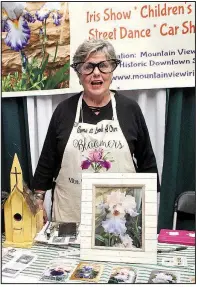  ?? Arkansas Democrat-Gazette/CELIA STOREY ?? Pat “Aunt Minnie” Cash talks up the Mountain View Iris Fest to visitors of the nonprofits booths lining the perimeter of Barton Coliseum at the 2018 Arkansas Flower &amp; Garden Show.