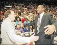  ?? THE ASSOCIATED PRESS FILE PHOTO ?? Magic Johnson, during his brief stint as Lakers coach, greets his former coach Mike Dunleavy Sr., who was coaching the Bucks in 1994.