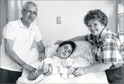  ?? CONTRIBUTE­D PHOTO ?? Arleen MacNeil, 20, the lone survivor of a quadruple shooting at the Sydney River McDonald’s restaurant on May 7, 1992, gives a thumbs-up at the Nova Scotia Rehabilita­tion Centre in Halifax on Sept. 23, 1992. Flanking MacNeil are her parents Howard and Germaine MacNeil of Bras d’Or.