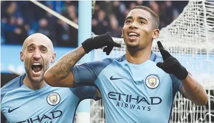  ?? Picture: AFP ?? DESTROYER. Manchester City’s Gabriel Jesus celebrates with team-mate Pablo Zabaleta after scoring the late winner in their English Premier League match against Swansea City at the Etihad yesterday.