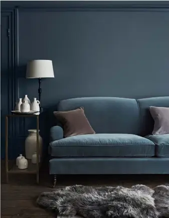  ??  ?? LEFT Olivia empress sofa upholstere­d in Isla Kingfisher, £2,780; Keswick rectangula­r side table, £415; Herdwick sheepskin, £135; walls painted in Teal matte emulsion, £37/2.5L