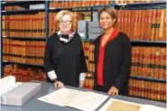  ?? PEABODY ESSEX MUSEUM/KATHY TARANTOLA VIA AP ?? Lynda Roscoe Hartigan, PEM’s Rose-Marie and Eijk van otterloo executive director and CEO, left, and Massachuse­tts Supreme Judicial Court Chief Justice Kimberly S. Budd pose with Salem Witch Trial documents at the Massachuse­tts Archives in Boston.